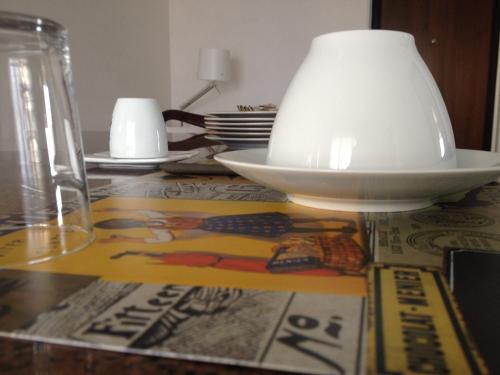 a table with a bowl and a lamp on it at B&B Via Roma suite in Ortona