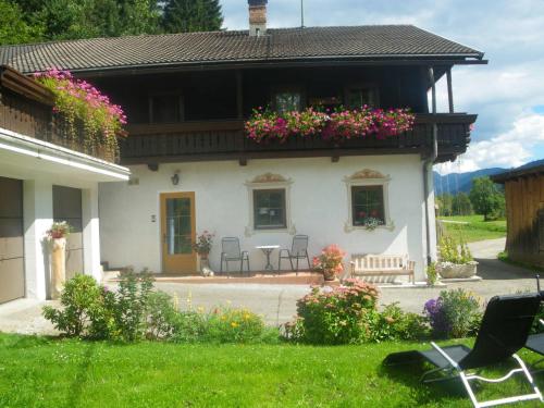 a house with a balcony with flowers on it at Weitlaner Birgit in Sillian