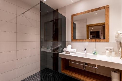 a bathroom with a sink and a shower at Luxapart Haus 2 in Ladis