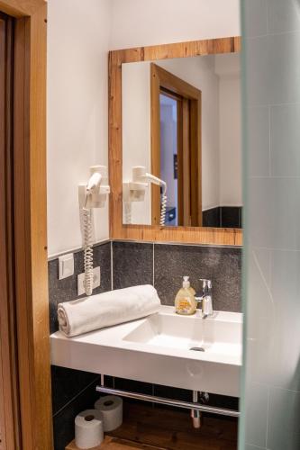a bathroom with a sink and a mirror at Luxapart Haus 2 in Ladis