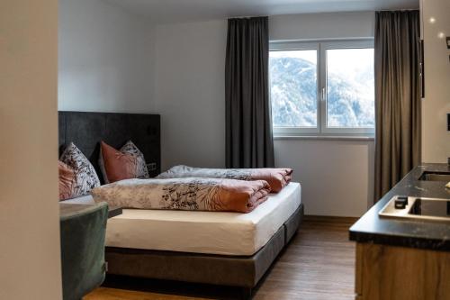 a bedroom with a bed in front of a window at Luxapart Haus 2 in Ladis