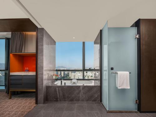 Ένα ή περισσότερα κρεβάτια σε δωμάτιο στο Grand New Century Hotel Wenzhou