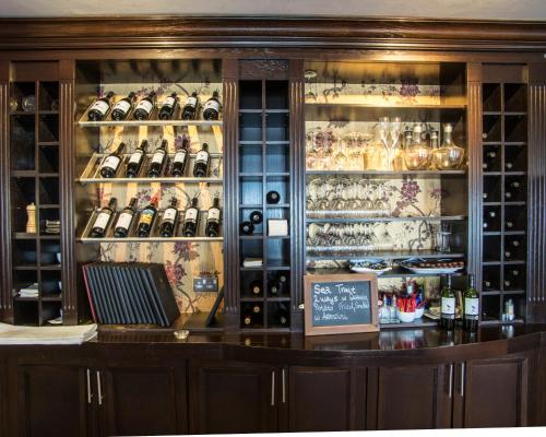 a display case in a store filled with lots of wine bottles at Kettles Country House Hotel in Swords