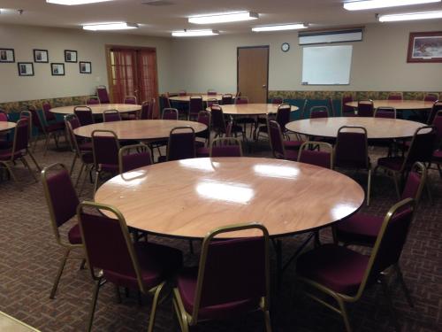 an empty room with tables and chairs in a classroom at Governors Inn a Travelodge by Wyndham in Pierre
