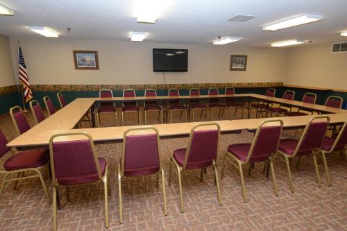 a conference room with a large table and chairs at Governors Inn a Travelodge by Wyndham in Pierre