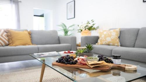 a living room with a tray of fruit on a table at 8 on Clarence in Moss Vale