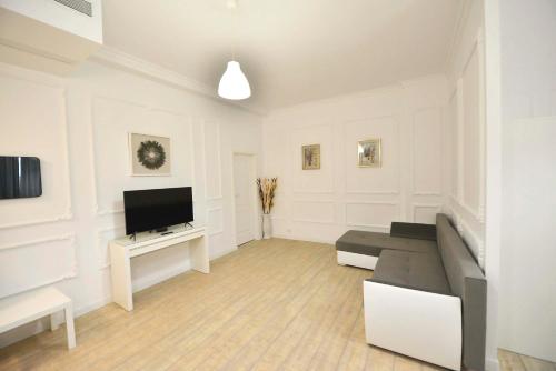 a living room with a couch and a flat screen tv at Otilia in Bucharest
