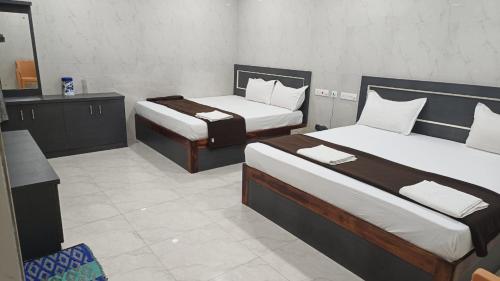 Katil atau katil-katil dalam bilik di HOTEL DIVINE RAMESHWARAM