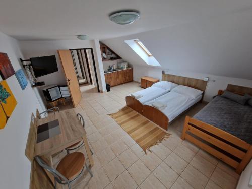 a large room with a bed and a couch and a table at Penzion Solna Jaskyna in Turčianske Teplice