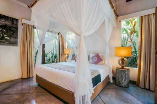 a bedroom with a bed with a canopy at Contemporary Balinese 4BR Private Villa in Umalas in Kerobokan