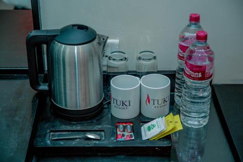 a counter with two cups and two bottles of water at Tuki Resort Pokhara in Pokhara
