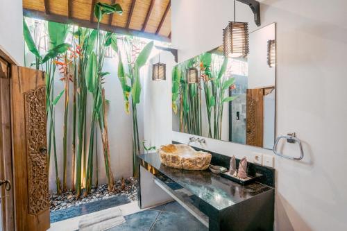 a bathroom with a large mural of bamboo at Contemporary Balinese 4BR Private Villa in Umalas in Kerobokan