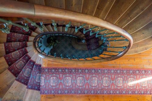 a spiral staircase in a wooden building with a rug at H de Surgères in Surgères