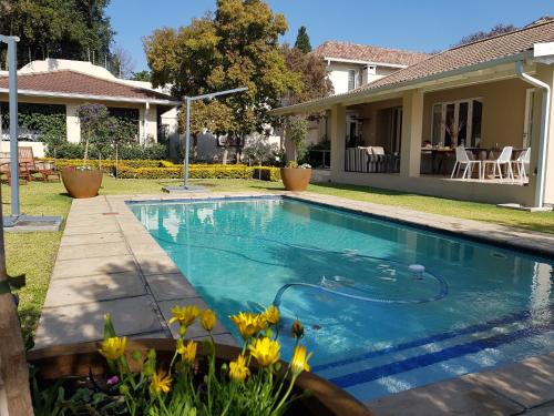a swimming pool in the yard of a house at Q on First B&B in Johannesburg