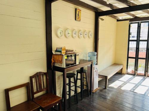 a room with a table and chairs and a bench at 146 Canal in Bangkok