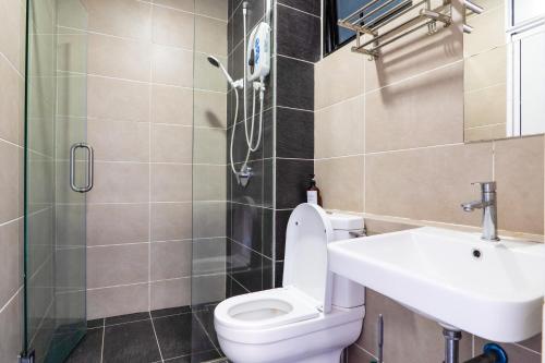 a bathroom with a toilet and a sink and a shower at D'Pristine Theme Suite by Nest Home at LEGOLAND in Nusajaya