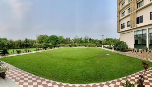 a large green field in front of a building at The Greenwood, Tezpur in Tezpur