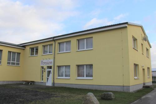 a yellow building with a sign that reads prison at Pension Leyerhof in Wendisch Baggendorf