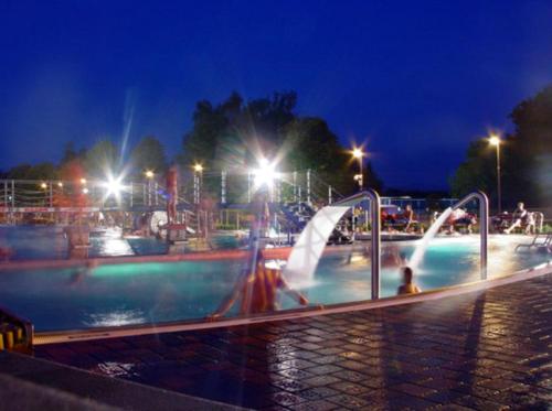 a water park at night with people playing in it at Hotel Terasa in Frýdek-Místek