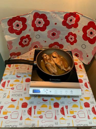 a bowl of food sitting on a table next to a stove at YokosoCEBU & Private Parking in Cebu City