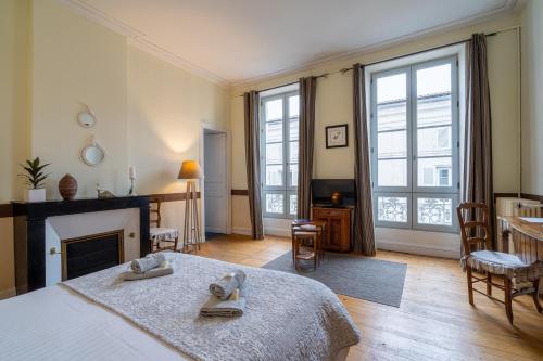 a living room with a bed and a fireplace at H de Surgères in Surgères