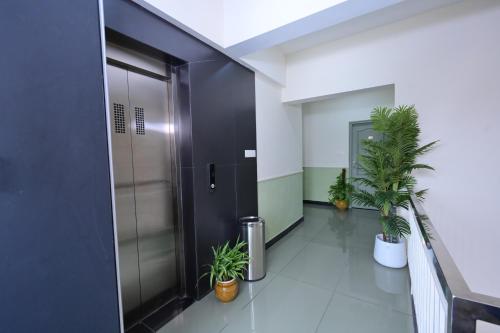 an elevator in an office with potted plants at RG's The 4th Residency in Trivandrum