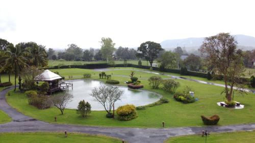a park with a pond and a gazebo at ทิพย์วาริน รีสอร์ท เขาใหญ่ in Ban Tha Chang