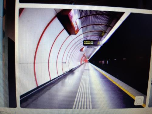 a tunnel with a long escalator in a subway at City terrace-apartment in Vienna
