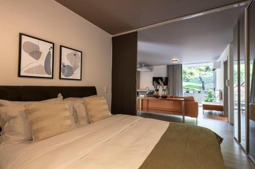 a bedroom with a large bed and a desk at Phaedrus Living: Luxury Flat Vouliagmeni in Athens