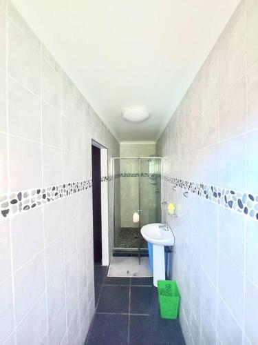 a bathroom with a shower and a toilet and a sink at Morningview Cottage - Self Catering Private Owned Rental in Durban