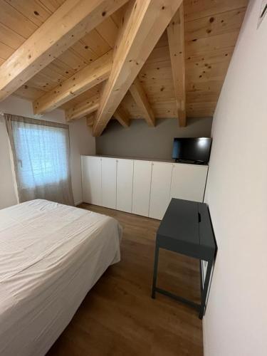 a bedroom with a bed and a black table at CASA PAOLA in Sala Bolognese