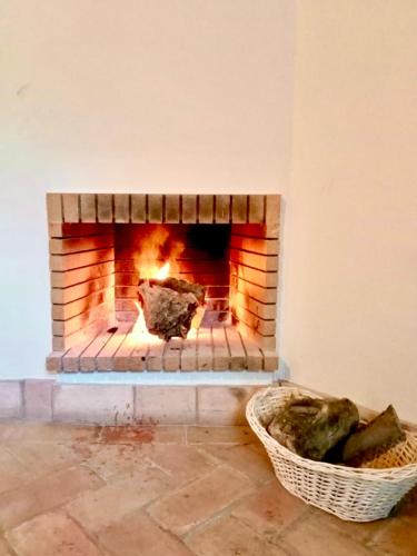 a brick fireplace in a room with a basket at El Rincón de las Descalzas in Carmona