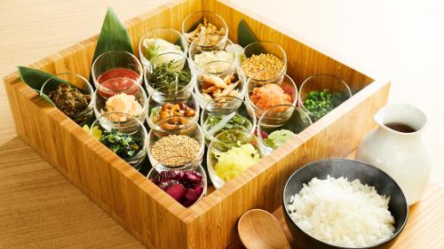 a wooden tray filled with different types of food at Hotel Intergate Tokyo Kyobashi in Tokyo