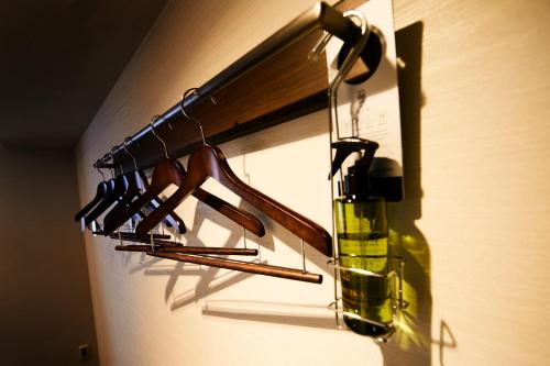 a rack of wine glasses and a bottle on a wall at Hotel Intergate Tokyo Kyobashi in Tokyo