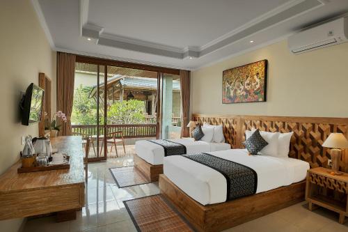 Postel nebo postele na pokoji v ubytování Gynandha Ubud Cottage