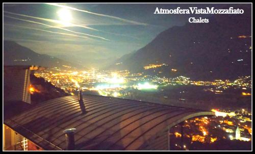 a view of a city at night from a building at CHALET con JACUZZI VISTA MONTAGNE in Aosta