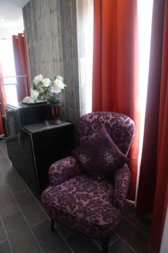 a purple chair sitting in a room with a window at Green Monkey Resort Boracay in Boracay
