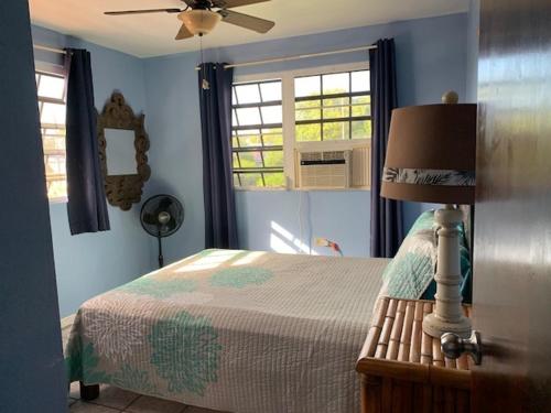 a bedroom with a bed and a ceiling fan at Esperanza Inn Guesthouse in Vieques