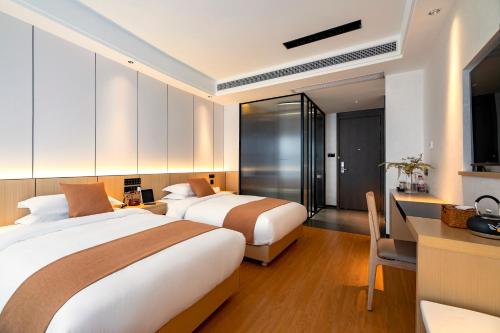 Postel nebo postele na pokoji v ubytování Cheng Jin Hotel