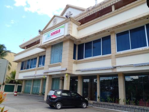 a car parked in front of a building at THE IGNISLO HOTEL SORONG in Sorong