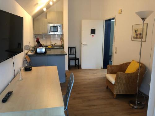 a kitchen with a table and chairs in a room at Apartmenthaus Somborn in Bochum
