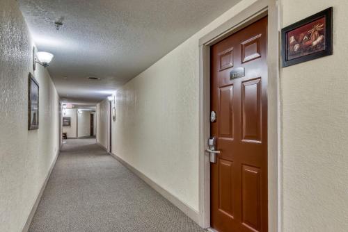 a hallway with a brown door in a building at Owl See You 3205 - Close to Dollywood and Overlooking Gatlinburg Golf Course condo in Pigeon Forge