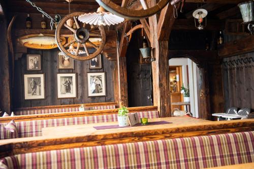 a dining room with a wooden table and a chandelier at Sporthotel Radstadt in Radstadt