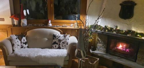 a living room with a chair and a fireplace at Hotel Dente Del Gigante in Courmayeur