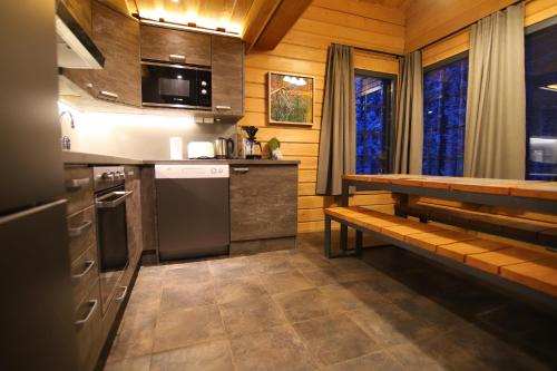 a small kitchen with a bench in a cabin at Tunturipöllö 2 in Ruka