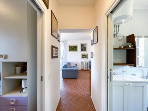a hallway leading to a living room with a blue couch at Appartamento Laura in Portoferraio