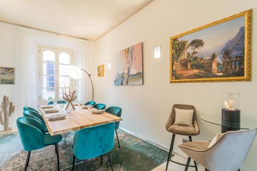 comedor con mesa de madera y sillas azules en Rovelli 41 by Rent All Como, en Como