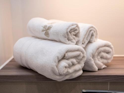 a pile of towels sitting on top of a table at Pass the Keys Spacious Bright Flat 20 Mins To Central London in London