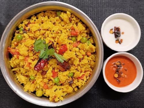 a bowl of rice with vegetables and a bowl of sauce at Fortune Park Kufri, Shimla - Member ITC Hotels' Group in Shimla