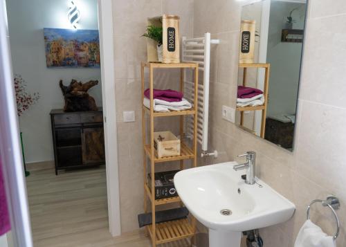 a bathroom with a sink and a mirror at La Casita de Lucia in Trescasas